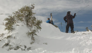 skier hiking up mount mansfield in vermont