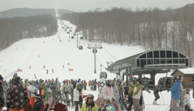 skier hiking up mount mansfield in vermont